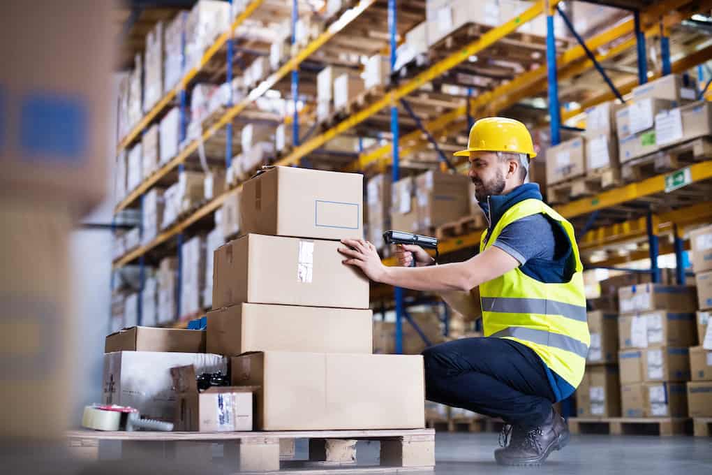 warehouse worker with rf scanner before shipping